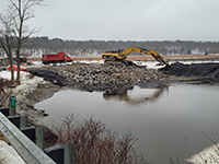 Constructing temporary roadway through ponded area next to George Wright Rd.